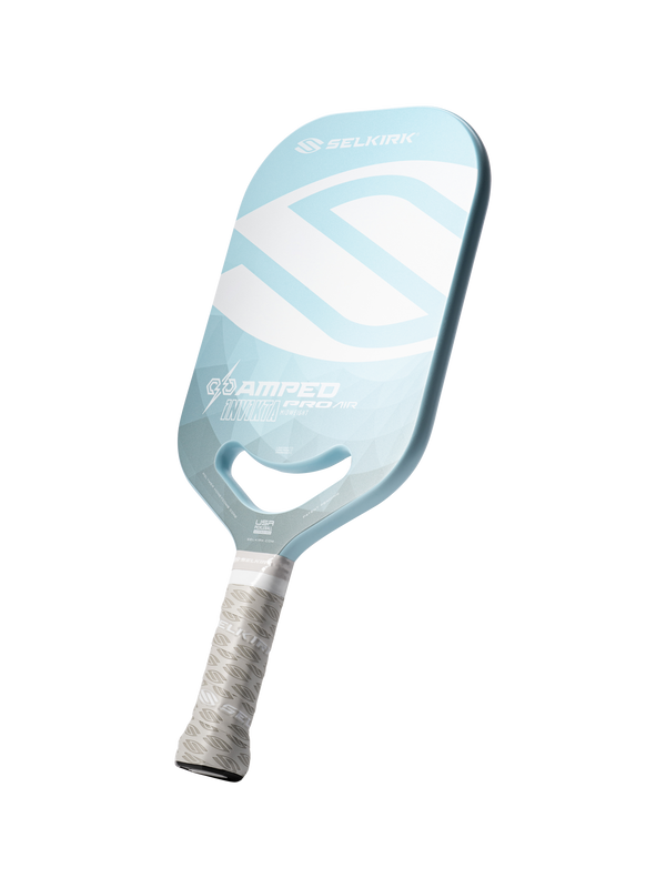 Light blue paddle labeled SELKIRK, AMPED INVICTA PRO AIR and USA; white patterned grip and handle cutout