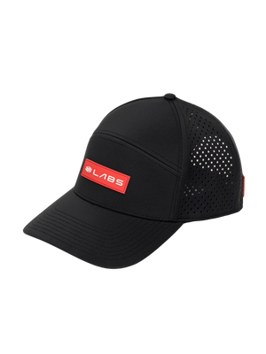 Three-quarter view of Selkirk LABS flat-bill snapback showcasing red LABS patch, perforated side panels on black background
