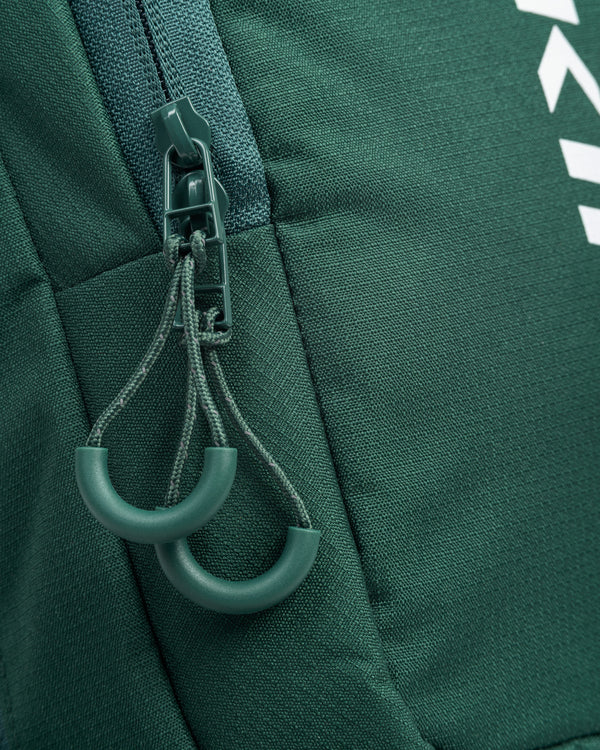 Close-up of zipper pullers on Core Line Pickleball Sling Bag in Forest Green