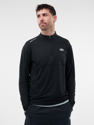 Man wearing black long-sleeve quarter-zip athletic top with small 'S' chest logo and SELECTRIX text on the right shoulder.