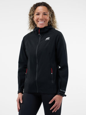 Smiling woman wearing black Selkirk hooded softshell jacket with red zip pulls