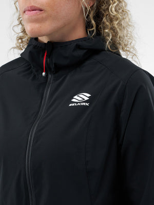 Close-up of person wearing black hooded zip jacket with white SELKIRK logo on the chest