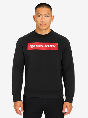 Man wearing black crewneck sweatshirt with red rectangular SELKIRK logo centered on chest
