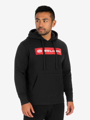 Male model in black hoodie with red SELKIRK logo, hands at sides, looking right