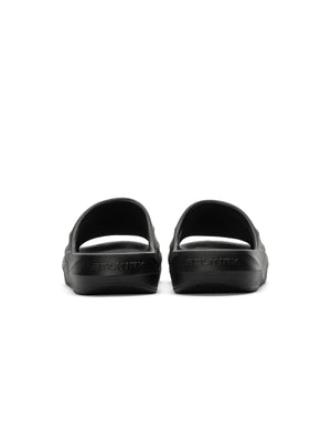 Black slide sandals shown from rear with embossed SELKIRK logo on heels
