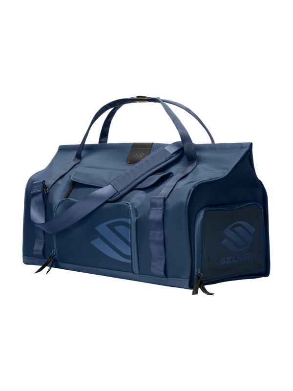 Front-right view of Selkirk Pro Line 2.0 duffel bag with top handles, padded shoulder strap and exterior zip pockets on dark background