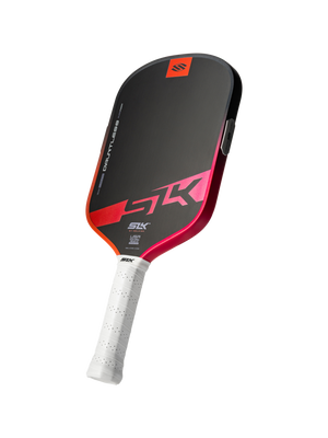 Angled view of SLK Dauntless elongated pickleball paddle showcasing black face with pink-red gradient edge and white perforated grip on transparent background