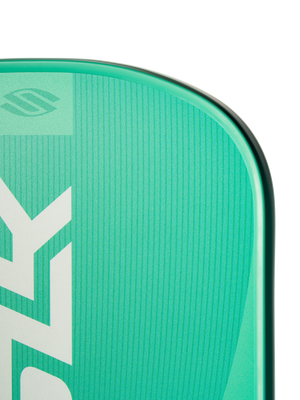 Close-up of SLK Valkyrie pickleball paddle corner showcasing vertical SLK branding, textured face ridges and rounded rail